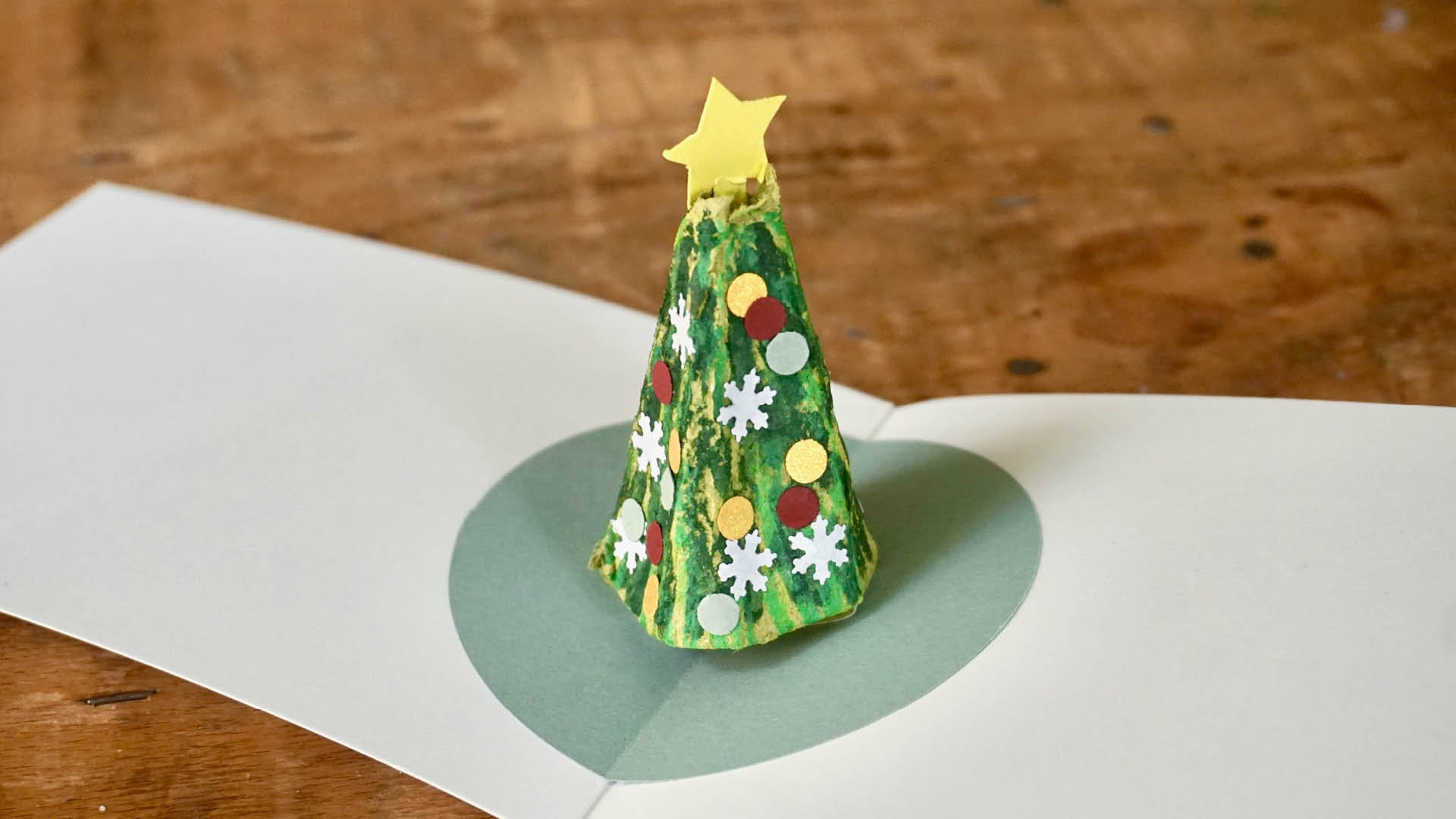 Beispiehafte Karte mit Stern auf Baum und mit Konfetti bekleb